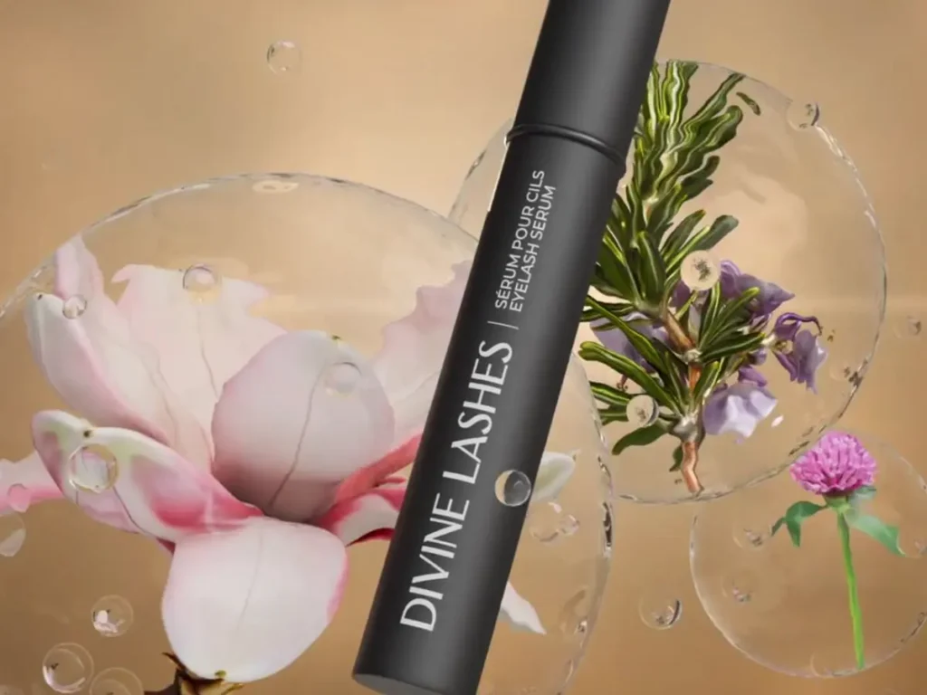 A lifestyle shot of the sleek black Divine Lashes Eyelash Serum next to several natural botanical ingredients.